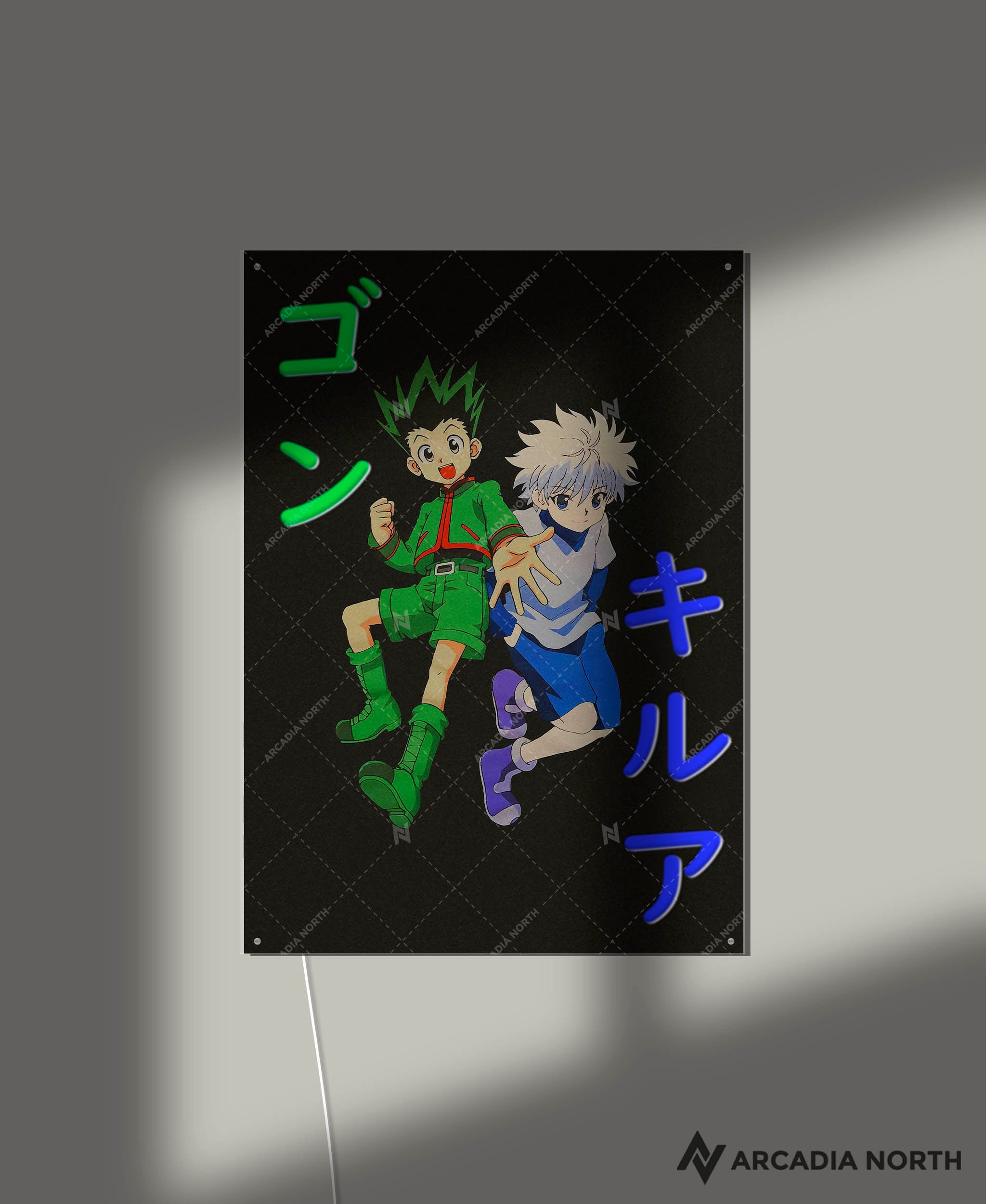 Arcadia North AURALIGHT - an LED Poster featuring the anime Hunter x Hunter with Gon and Killua and their names written in Japanese Katakana [ゴン] and [キルア]. The names are illuminated by glowing LED neon lights that match each character’s main color. UV-printed poster on acrylic.